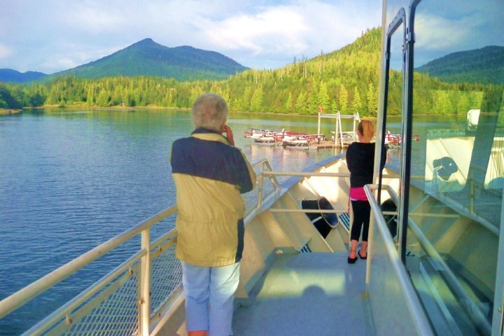 a man standing on a bridge over a body of water