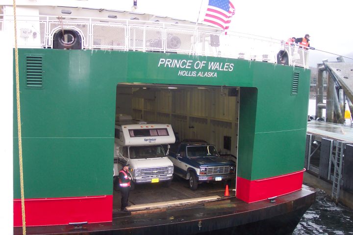 a green truck parked in front of a building
