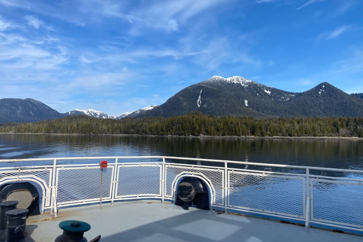 a bridge over a body of water with a mountain in the background