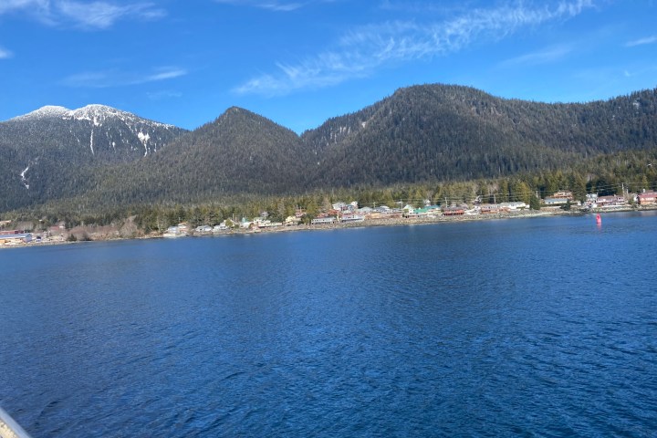 a body of water with a mountain in the background