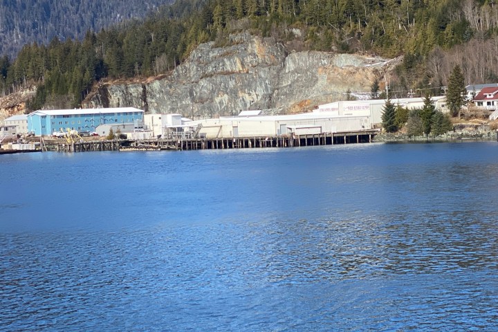 a large body of water with a mountain in the background