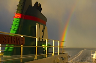 IMG_1848 The top deck of the Stikine and smokestack with the letters IFA sails along with a rainbow in the background with the boats wake.
