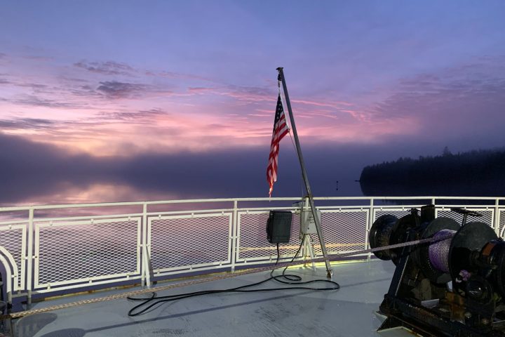 a boat sitting on top of a wooden fence