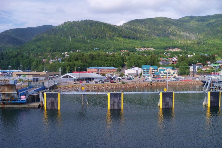 a small boat in a body of water with a mountain in the background
