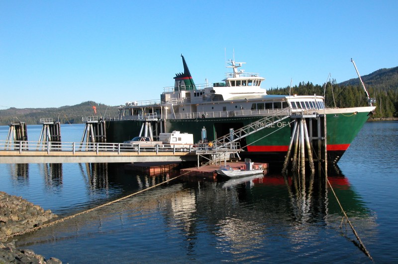 a boat is docked next to a body of water