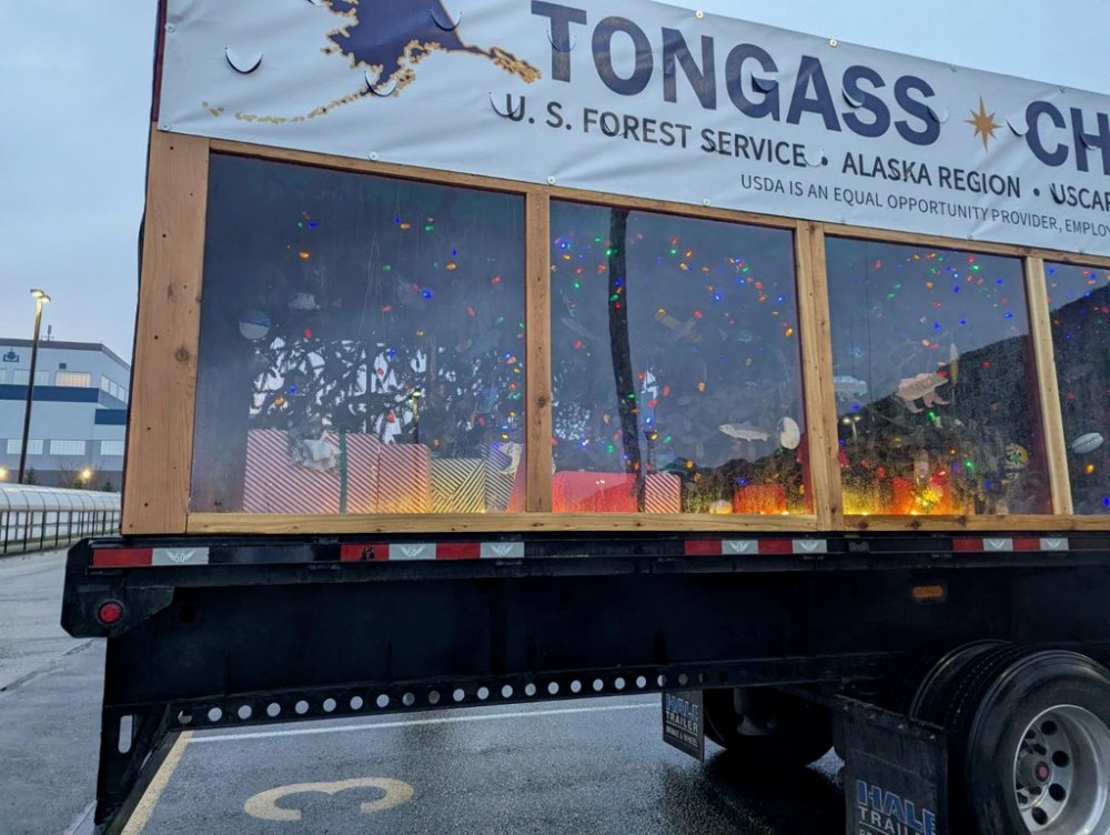 a truck that has a sign on the side of a road